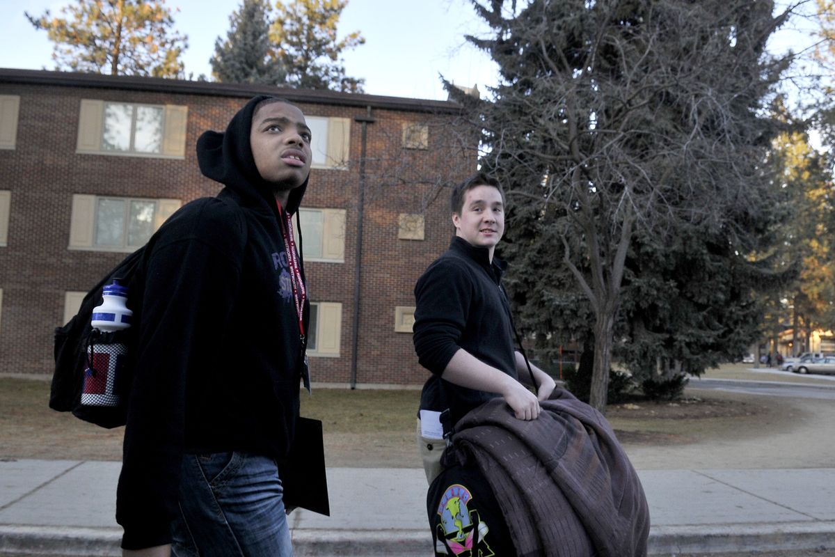 Rogers High student Jacolby Rivers, 17, left, listens as Whitworth sophomore Aaron Kilfoyle talks about the campus buildings as they walk to a dorm Thursday, the first of a three-day program to introduce college life to a group of Rogers students. (Jesse Tinsley)