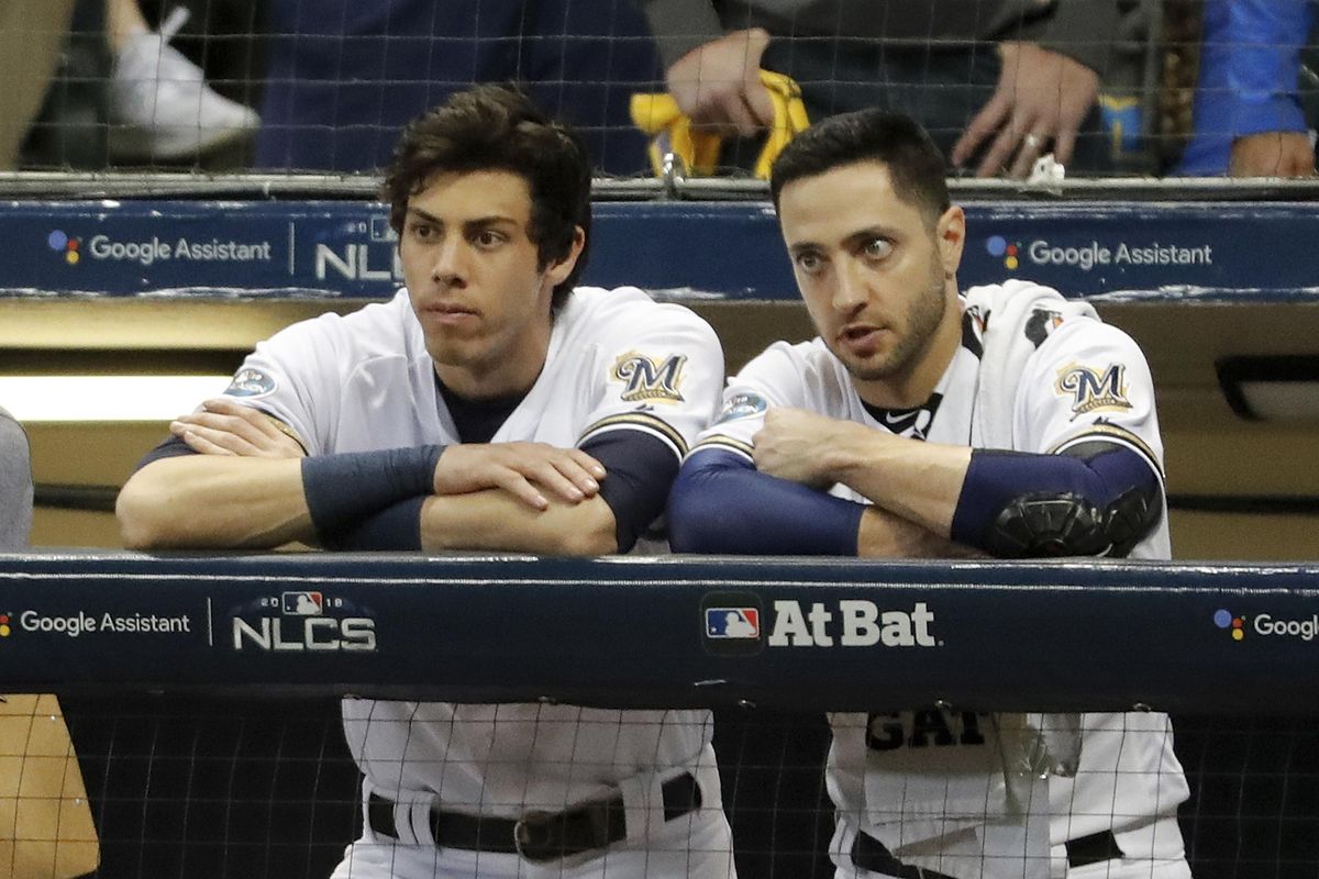 Milwaukee’s Christian Yelich, left, and Ryan Braun watch during the ninth inning of Game 7 of the National League Championship Series against the Los Angeles Dodgers on Saturday in Milwaukee. The Dodgers won 5-1. (Jeff Roberson / AP)