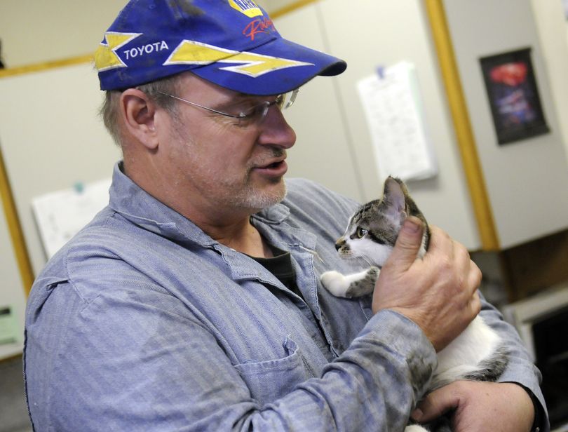 Bus mechanic Everett Combs holds Eve. Combs is the one who found the stray kitten near the Freeman School District bus barn.