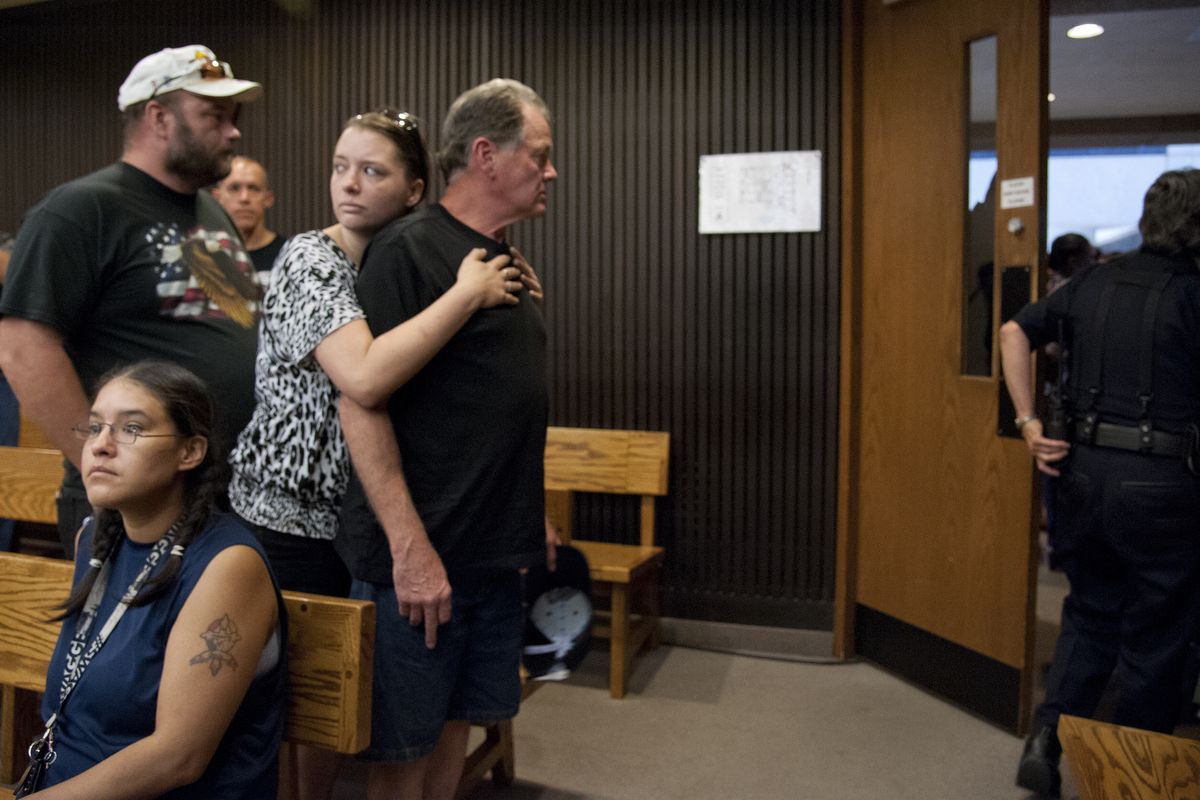 Ted Denison, Laura Gates and Rick Gibson, friends of Delbert Belton, wait for the courtroom to clear Tuesday after Kenan Adams-Kinard’s first appearance. (Dan Pelle)