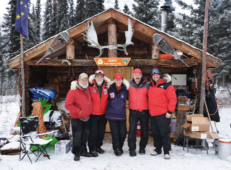 The crew at Rohn Checkpoint on the Iditarod Trail pose with two Washington snowmobilers. Josh Rindal of Spokane and Bob Jones of Kettle Falls were snowmobiling 1,400-miles along the route of Alaska's famous Iditarod Sled Dog Race in March 2014. (Robert Jones)