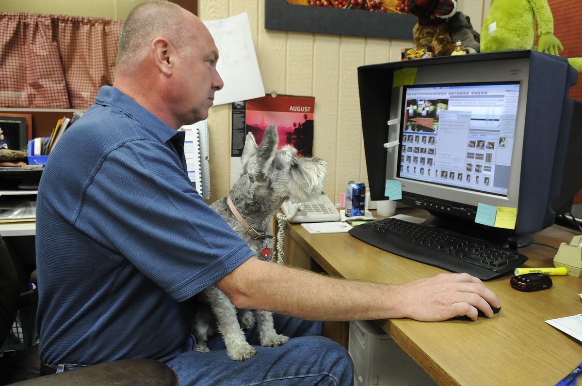 Steve Riffle, of R&R Custom Color Lab,  and his dog, Lola, demonstrate the software on his Web site.  (Dan Pelle / The Spokesman-Review)