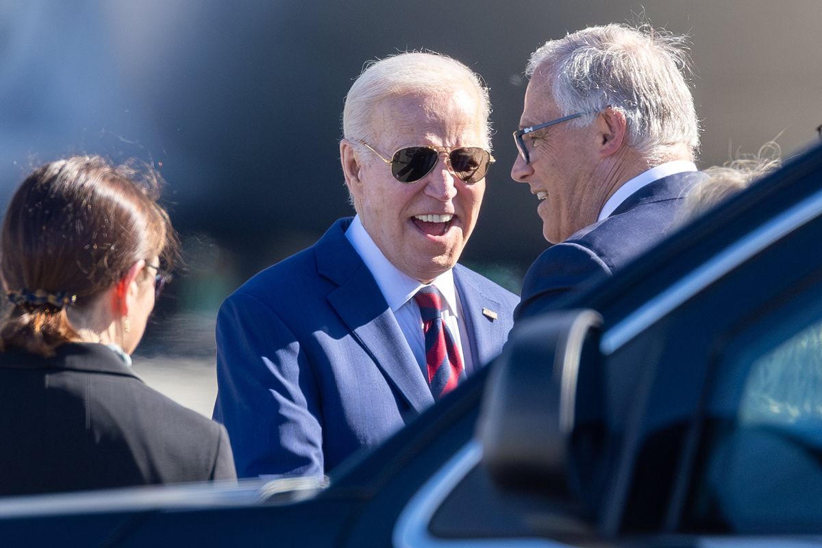 President Joe Biden greets Gov. Jay Inslee on Friday at the Seattle-Tacoma International Airport.  (Kevin Clark/Seattle Times)
