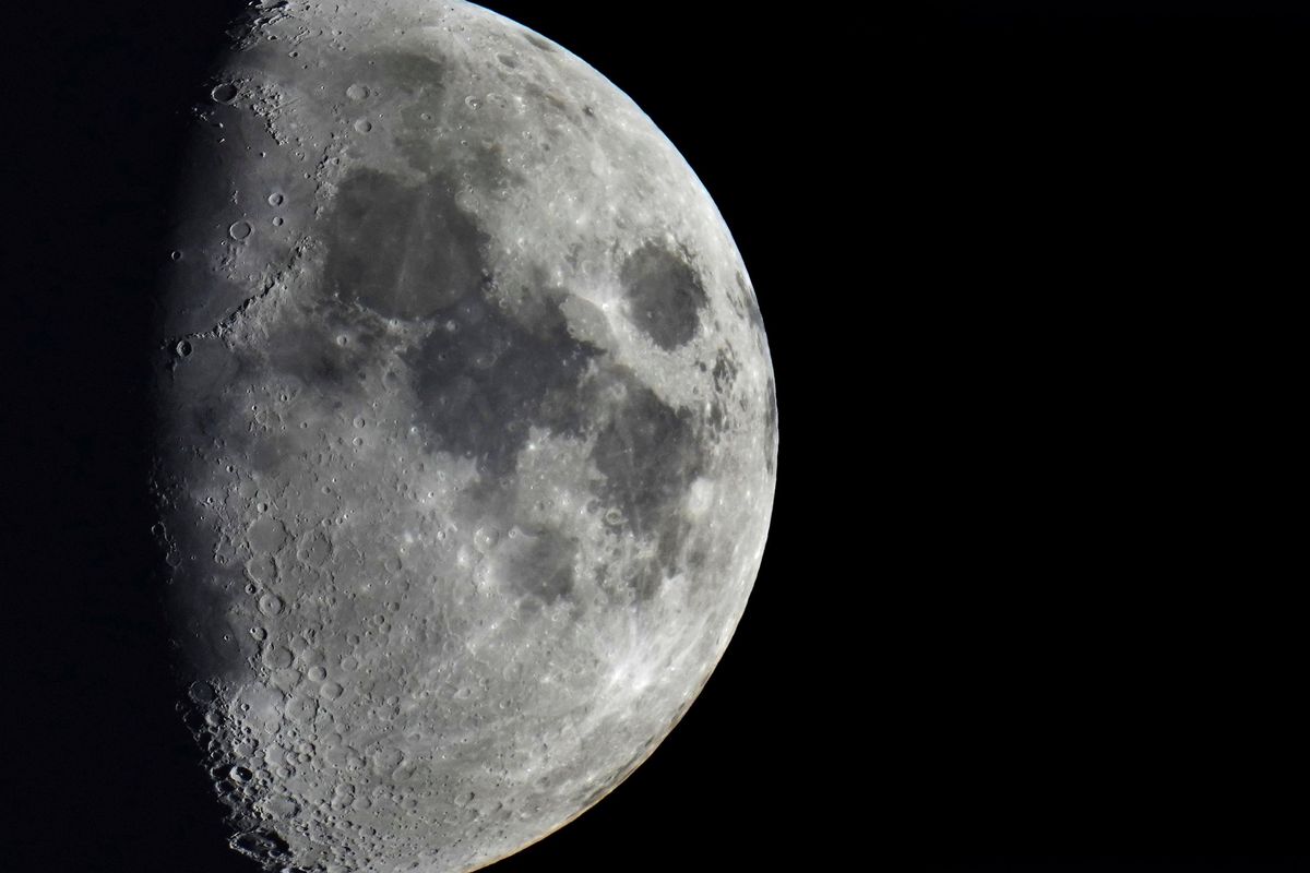 FILE - Impact craters cover the surface of the moon, seen from Berlin, Germany, Tuesday, Jan. 11, 2022. The moon is about to get walloped by 3 tons of space junk, a punch that will carve out a crater that could fit several semitractor-trailers. A leftover rocket is expected to smash into the far side of the moon at 5,800 mph (9,300 kph) on Friday, March 4, 2022, away from telescopes’ prying eyes. It may take weeks, even months, to confirm the impact through satellite images.  (Michael Sohn)