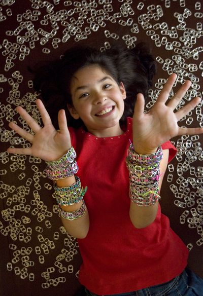  Parker Salinas, 10, wears can tab bracelets that she makes and sells to help raise money for breast cancer research in Roswell, Ga.  (Associated Press)