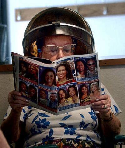 
Gwen Sherman flips through a gossip magazine while waiting for her curls to set at the Top Options Hair Salon. Sherman has been going to her stylist, Eileen Moffitt, for years. 
 (The Spokesman-Review)