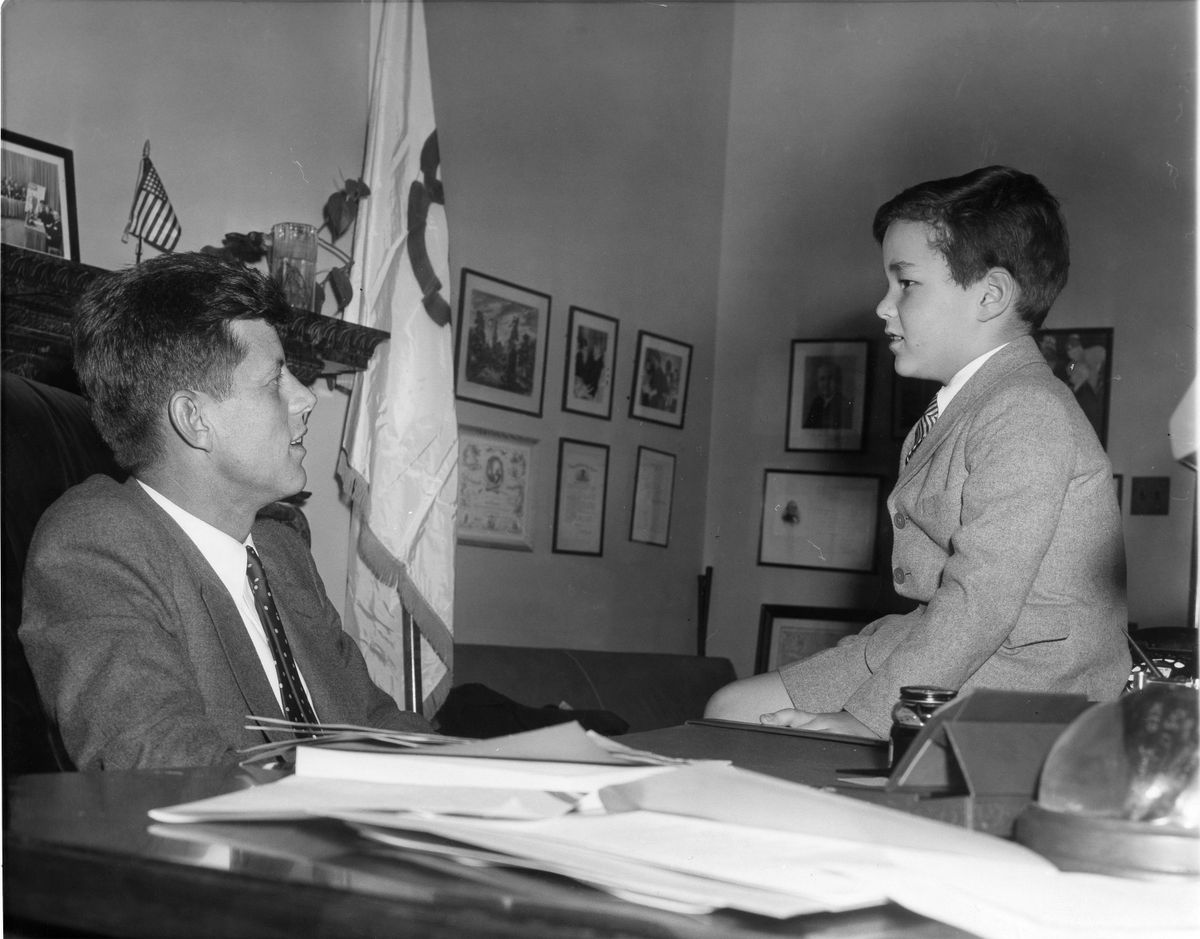 In this February 1954 photo obtained from the John F. Kennedy Presidential Library and Museum in Boston, James Auchincloss, 6, talks with Sen. John F. Kennedy in Washington, D.C.  (File Associated Press / The Spokesman-Review)