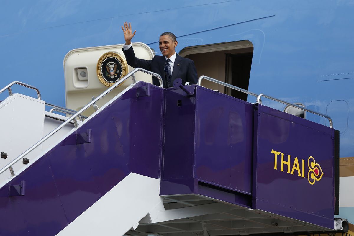 U.S. President Barack Obama waves as he steps off Air Force One at Don Mueang International Airport in Bangkok, Thailand, Sunday, Nov. 18, 2012. (Carolyn Kaster / Associated Press)
