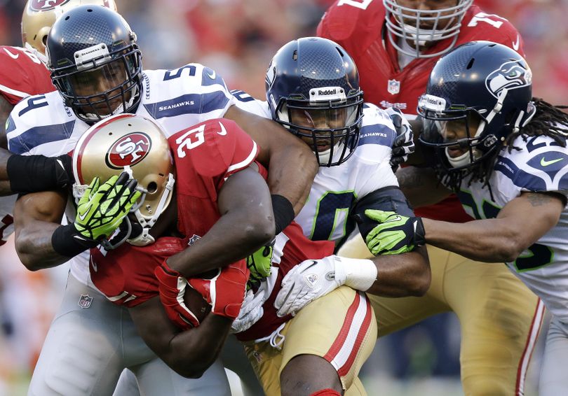 For now, Bobby Wagner, rear, is highest-paid middle linebacker. (Associated Press)