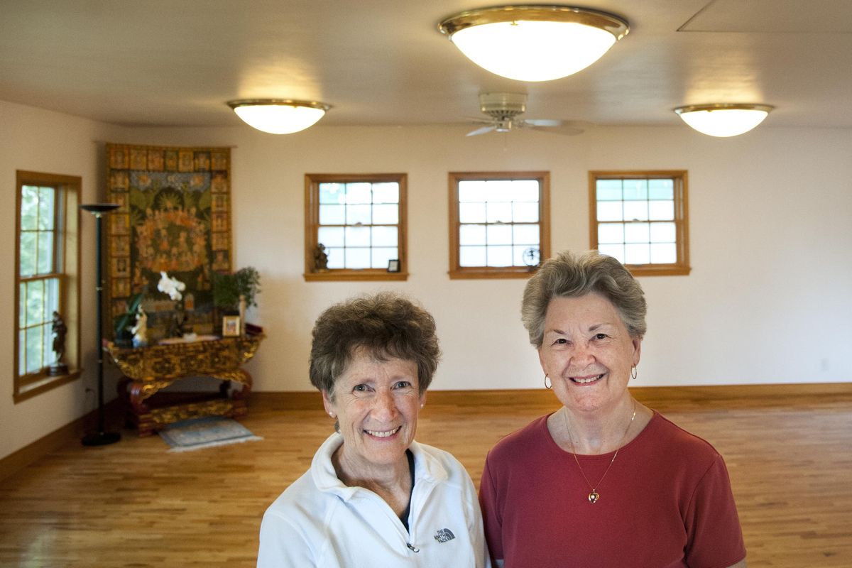 Dawn Spickler, left, and Janet Brown are pictured at Yasodhara Yoga in Spokane’s Browne’s Addition in 2014. (Dan Pelle / The Spokesman-Review)