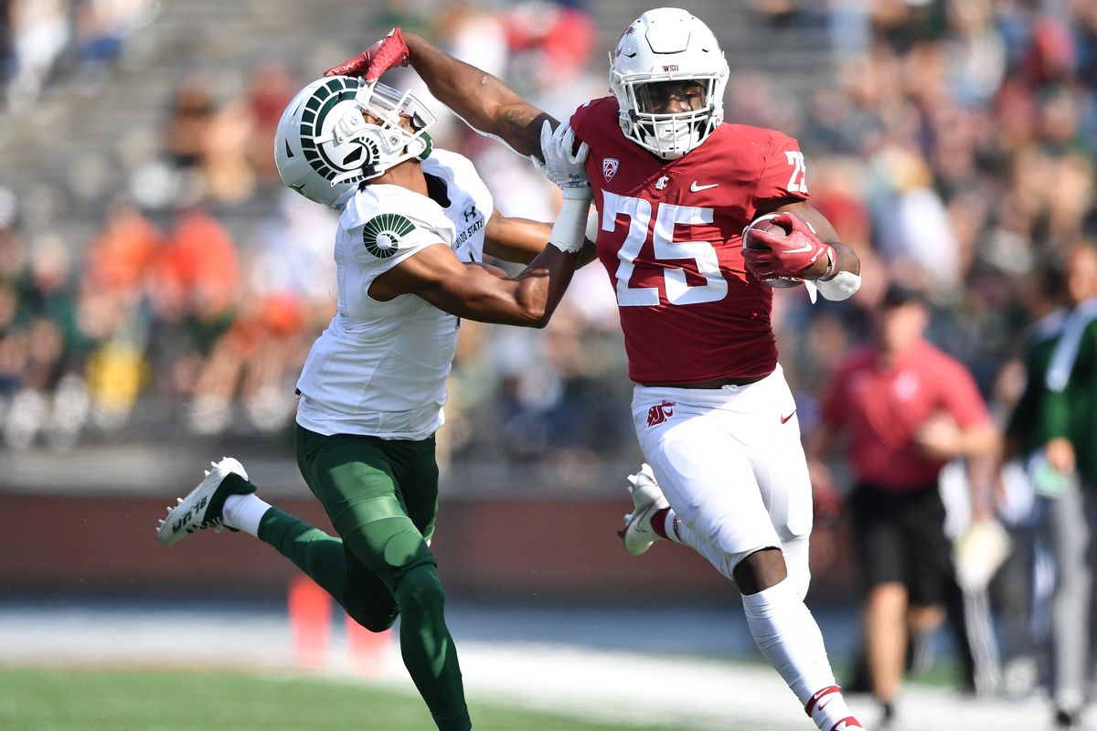 Washington State Cougars running back Nakia Watson (25) shakes a tackle from Colorado State Rams defensive back Angel King (4) during the first half of a college football game on Saturday, Sept. 17, 2022, at Martin Stadium in Pullman, Wash.  (Tyler Tjomsland/The Spokesman-Review)