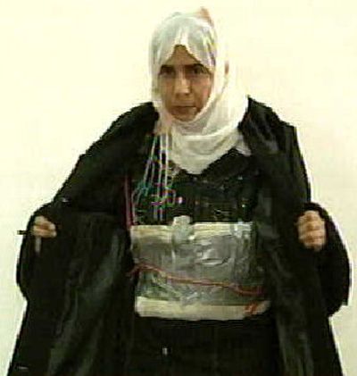 
Iraqi Sajida Rishawi, 35, opens her jacket and shows an explosives belt as she confesses on Jordanian state-run television on Sunday to her failed bid to set off an explosives belt inside one of the three hotels in Amman, Jordan, targeted by al-Qaida. 
 (Associated Press / The Spokesman-Review)