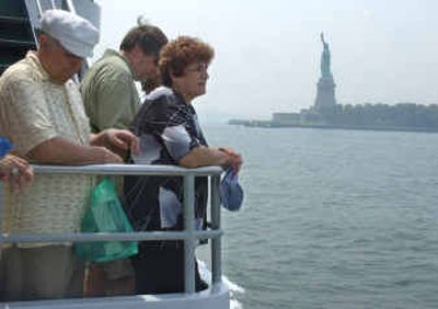 
Riva Davydow, right, and Ilya Davydow, left, of Ramla, Israel, return from visiting Liberty Island on Monday, one day before the Statue of Liberty reopens its doors to the public for the first time since its closure on Sept. 11, 2001. 
 (Associated Press / The Spokesman-Review)