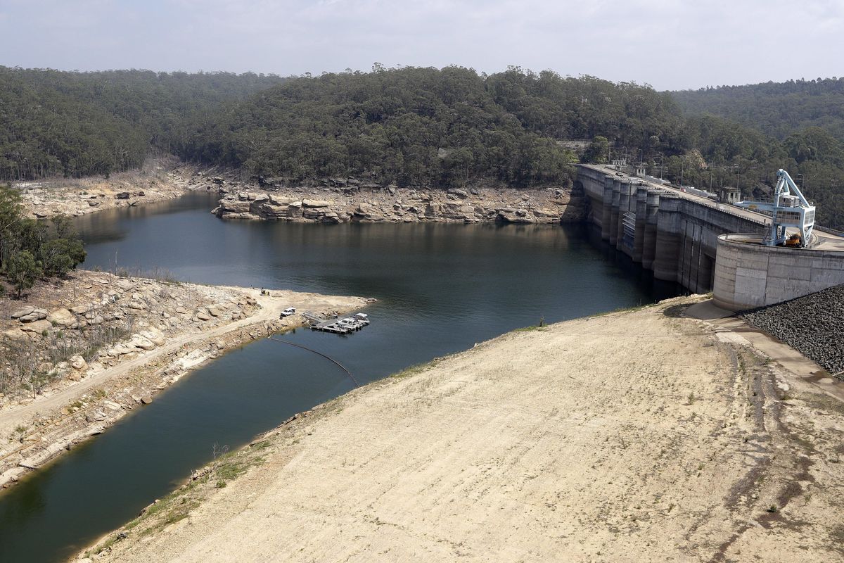 A boom floats across a small bay near the dam wall at Warragamba Dam in Warragamba, Australia, Wednesday, Jan. 29, 2020. Although there have been no major impacts on drinking water yet from the intense wildfires, authorities know from experience that the risks will be elevated for years while the damaged catchment areas, including pine and eucalyptus forests, recover. (Rick Rycroft / Associated Press)