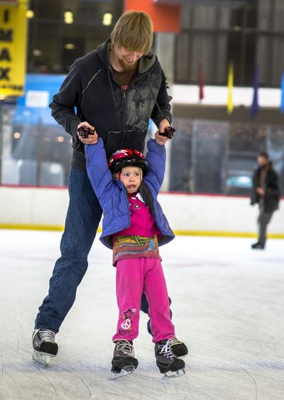 Hold on tight: With her father Nathan Vantine to guide her, Candace Vantine, 4, gives ice skating a try for the first time at Riverfront Park’s Ice Palace on Tuesday in downtown Spokane. Daytime hours for public skating are 11 a.m. to 5 p.m. every day except Mondays, when the venue is closed. Evening skating begins at 7 p.m. Wednesday through Saturday. (Colin Mulvany)