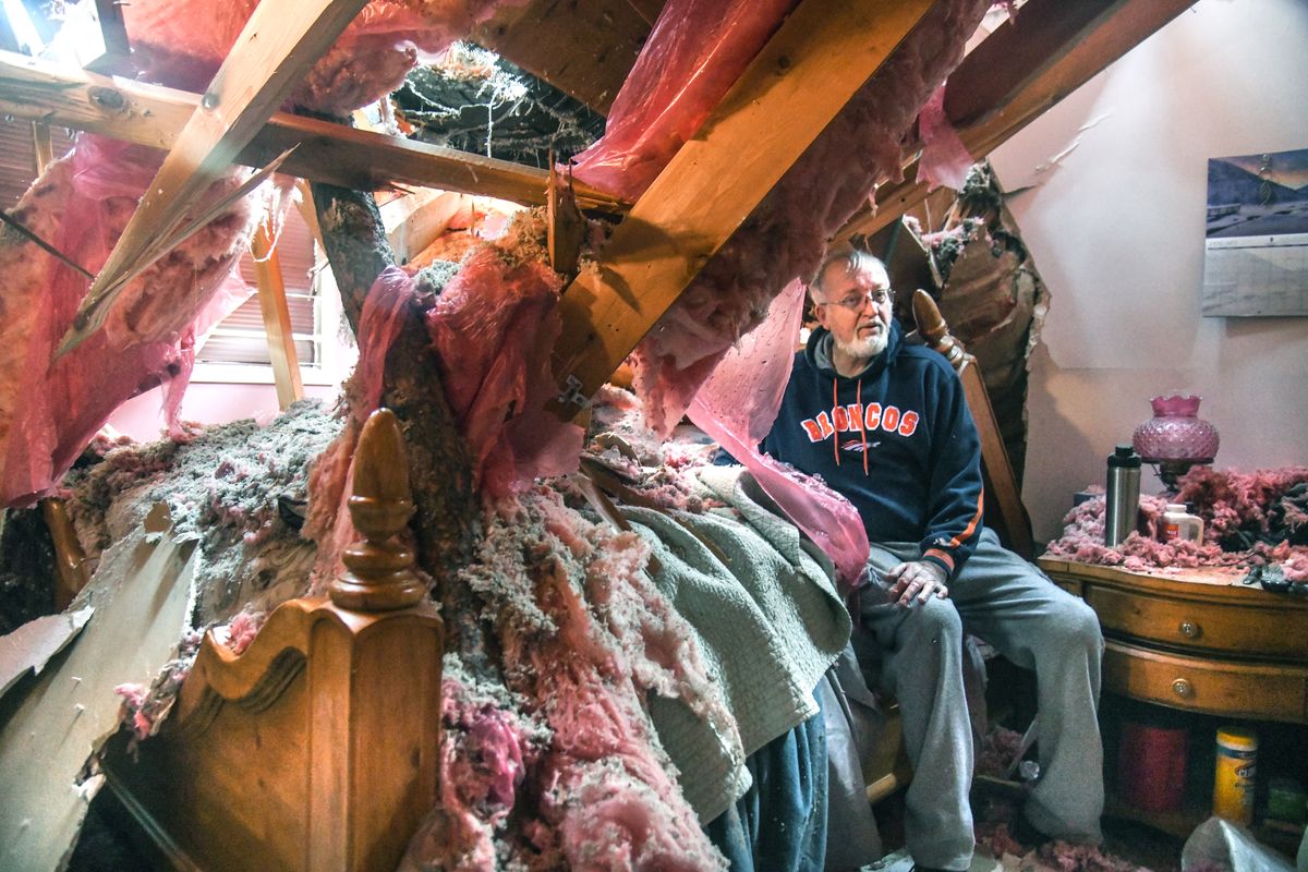 Bill Oliver, 81, was lucky to make it out of his bed alive after a pine tree crashed into his bed as he slept, Wednesday morning, Jan. 13, 2021 in Spokane Valley, Wash. High winds cause extensive damage throughout the area.  (DAN PELLE/THE SPOKESMAN-REVIEW)