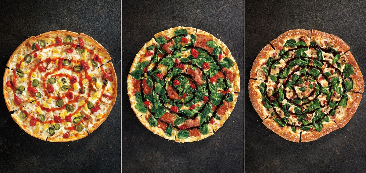This image from Pizza Hut shows the restaurant chain’s new specialty pizzas, from left, Sweet Sriracha Dynamite, Cherry Pepper Bombshell and Pretzel Piggy. The atypical flavors and new ingredients are part of a menu overhaul announced Monday. (Associated Press)