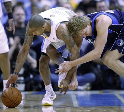 Denver’s Dahntay Jones, left, picks up a loose ball against Dallas’ Dirk Nowitzki during the Nuggets’ series-clinching win at Denver.  (Associated Press / The Spokesman-Review)