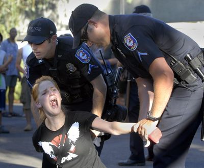 Demonstrator Cassie Kirkeby, protesting police brutality is arrested at the clock tower in Riverfront Park, July 4, 2007. (Dan Pelle / The Spokesman Review)