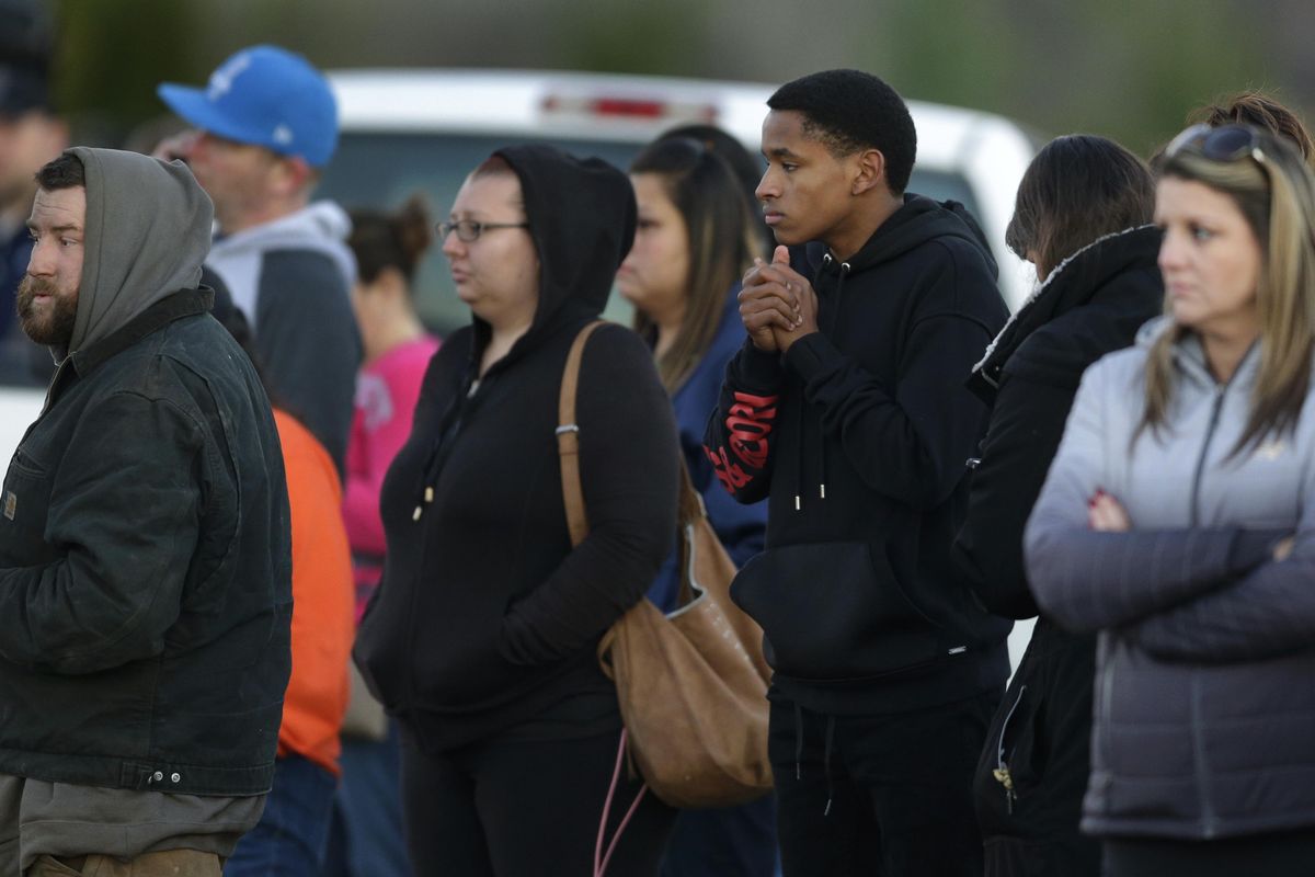 People wait to be reunited with students on lockdown near Graham-Kapowsin High School, Frontier Middle School, and Nelson Elementary School, Tuesday, Dec. 5, 2017, in Graham, Wash. Authorities said two students were shot near the high school Tuesday afternoon. (Ted S. Warren / Associated Press)