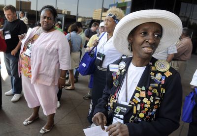 Delores Harris, right, of Memphis, Tenn., waits  at the Spokane Convention Center for a tour bus to take Neighborhoods, USA participants around the area Friday.   (Dan Pelle / The Spokesman-Review)