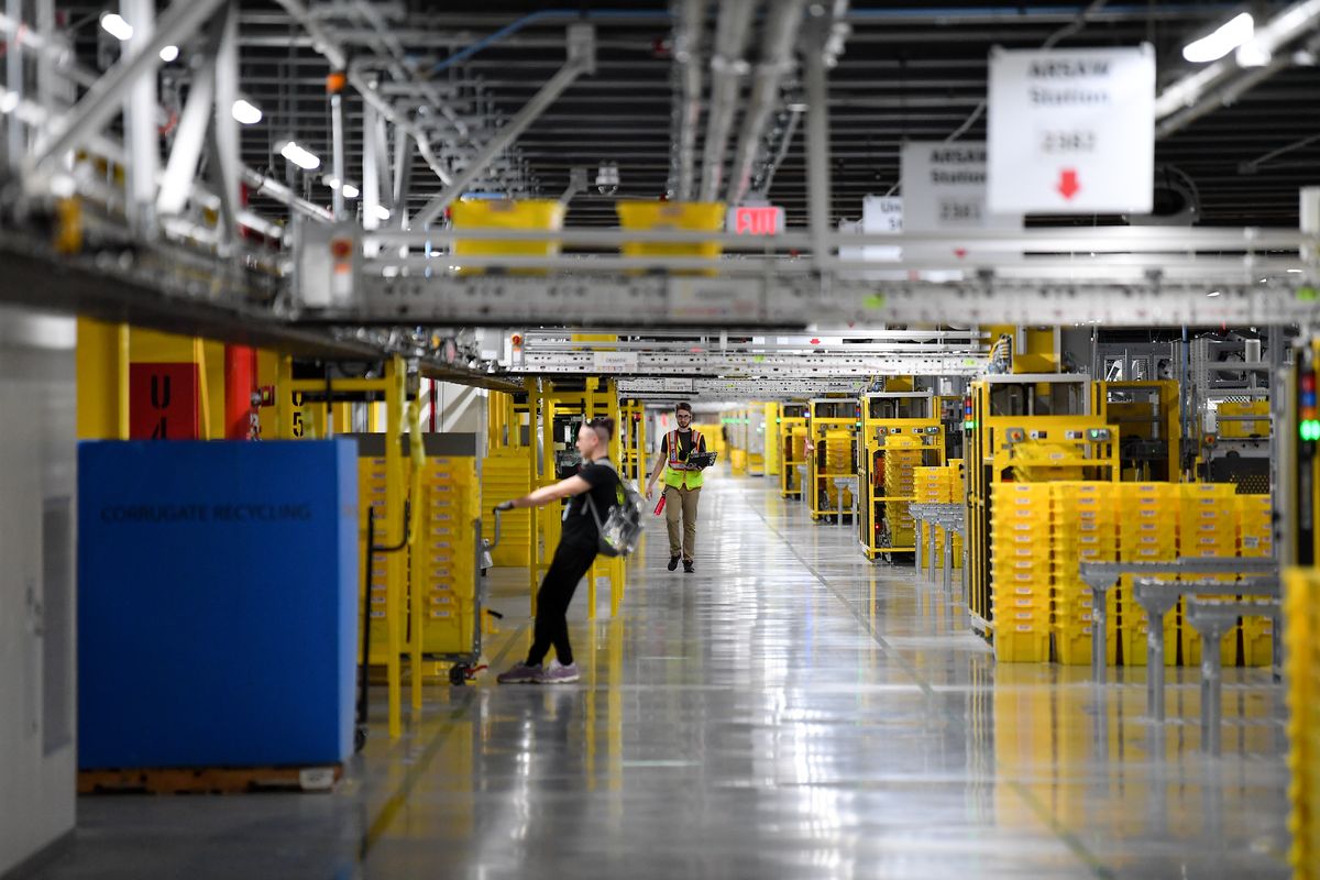 Employees work at Amazon’s Airway Heights fulfillment center on June 7, 2021.  (Tyler Tjomsland/The Spokesman-Review)