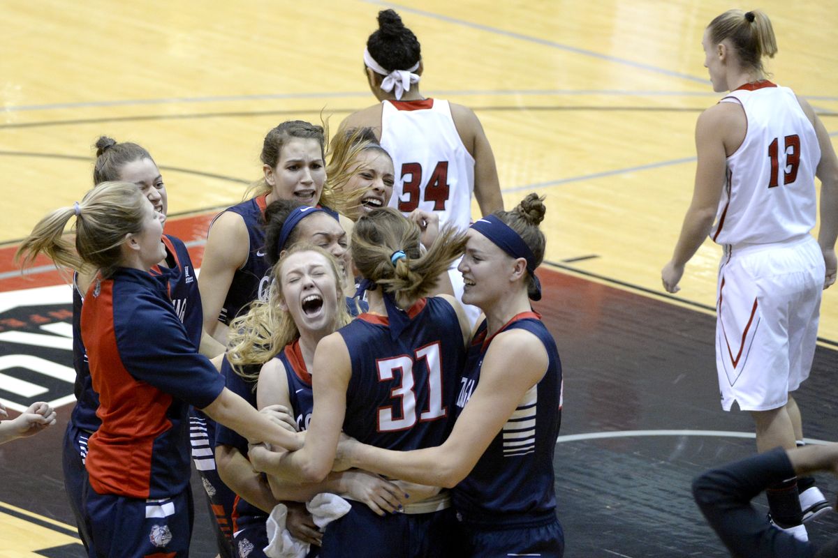 Elle Tinkle (31) is surrounded by Gonzaga teammates after her buzzer-beater Wednesday edged Eastern Washington at Reese Court. (Jesse Tinsley)