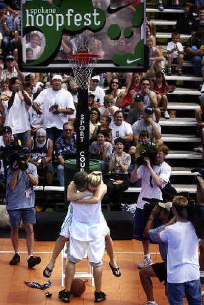 
Landen Grant, 22, is hugged by his new fiance Carli Smith, 20, after he proposed to her during the Hoopfest Dunk Contest in downtown Spokane.  
 (File/Spokesman-Review / The Spokesman-Review)