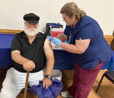 Kris Stablein, R.N., gives a dose of flu vaccine to Mike Walls, 66, of Erie, during the Flu Kickoff and Wellness Event on Aug. 29 in Erie, Pa.  (David Bruce/Erie Times-News)