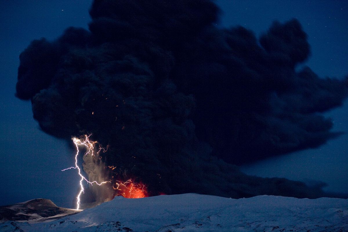 Lightning is seen amid the lava and ash erupting from the vent of the Eyjafjallajokull volcano in central Iceland early Sunday