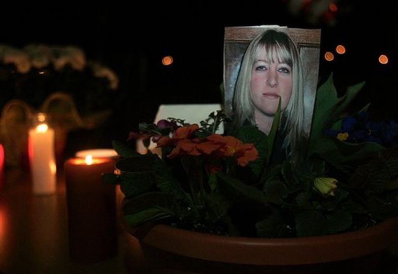 A photo of Jayme Biendl is surrounded by flowers and candles during a candlelight vigil outside the Monroe Correctional Complex in Monroe, Wash. Sunday, Jan. 30, 2011. Biendl was found dead Saturday night in the chapel at Monroe Correctional Complex (Sarah Weiser / (AP Photo/The Herald / Sarah Weiser))
