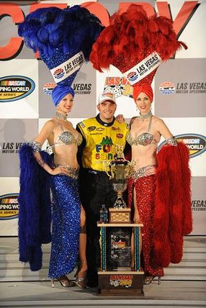 After winning the Las Vegas 350, Johnny Sauter poses with the Las Vegas Motor Speedway showgirls in victory lane. (Photo Credit: Harry How/Getty Images) (Harry How / The Spokesman-Review)