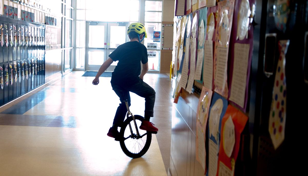 Duke Swanson, fifth-grader, rides through the halls during the after-school unicycle class at Jefferson Elementary in Spokane on Wednesday, March 13, 2019. (Kathy Plonka / The Spokesman-Review)