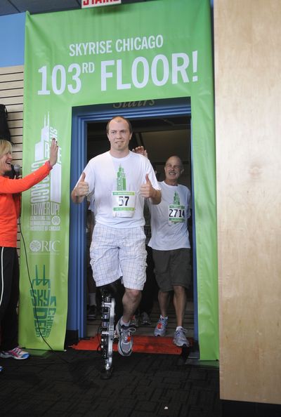 Zac Vawter, a 31-year-old amputee, emerges after walking up the stairs of the Willis Tower in Chicago on Sunday to become the first person to climb one of the world’s tallest skyscrapers with a bionic leg. (Associated Press)