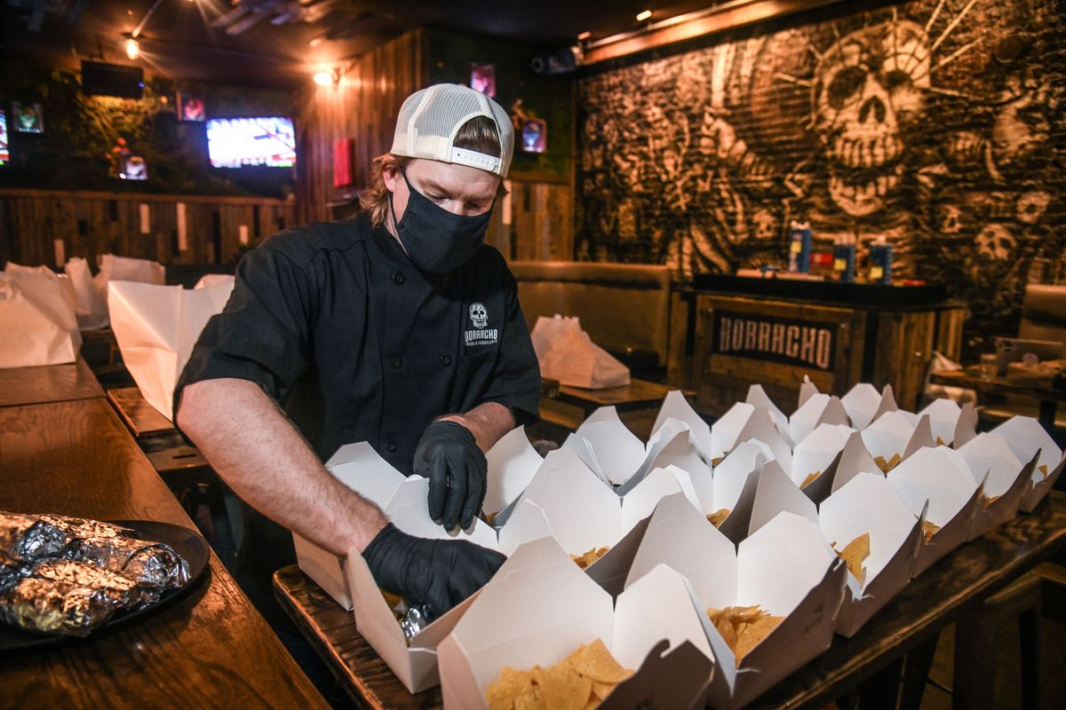Borracho Tacos & Tequileria manager Garrett Wellsandt, boxes some of the 65 burritos made on Thursday, Dec. 17, 2020, in Spokane. Spokane native Sydney Sweeney has donated $12,000 to distribute meals from 12 area restaurants to 12 area shelters as part of a special 12 Days of Christmas campaign. $1,000 worth of food is going to a shelter per day. This food was headed to the UGM Crisis Shelter for Women & Children.  (DAN PELLE/THE SPOKESMAN-REVIEW)