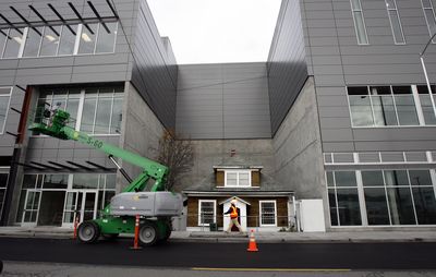 This  2008 file photo shows a new building in Ballard, Wash., surrounding Edith Macefield’s cottage. AP Photo/The Seattle Times, Alan Berner (File AP Photo/The Seattle Times, Alan Berner / The Spokesman-Review)