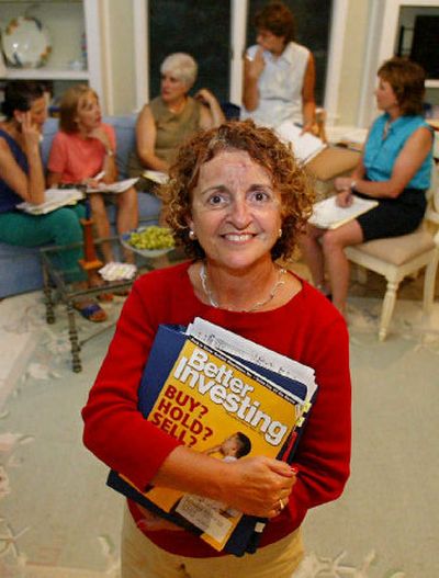 
Elaine Haddad stands in her home in North Andover, Mass. in front of other members of the Blue Chip Women's Investment Group. The group meets once a month to consider investments that the group can make together. 
 (Associated Press / The Spokesman-Review)
