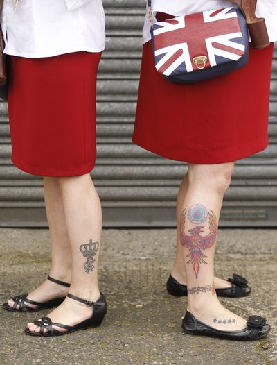Female members of the Orange Order prepare to parade in North Belfast, Northen Ireland, Thursday, July 12, 2012. The Twelfth of July is the busiest day of the marching season in Northern Ireland with thousands of Orangemen and women, accompanied by marching bands, taking part in hundreds of parades. The Orange Order holds its main Belfast event, which commemorates King William III's 1690 Battle of the Boyne victory over Catholic King James II. (Peter Morrison / Associated Press)