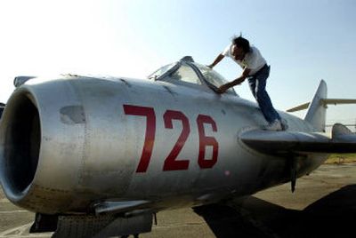 
Brenton Spencer tries to open the cockpit door of a Cold War MiG-17 aircraft next to an XN Air hangar last Wednesday. The plane was donated last year to Spokane's planned Armed Forces & Aerospace Museum, where it would be part of a proposed airplane exhibition. 
 (Holly Pickett / The Spokesman-Review)