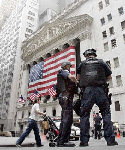 
Two New York City Police Dept. Emergency Services officers patrol outside the New York Stock Exchange Thursday morning.
 (The Spokesman-Review)
