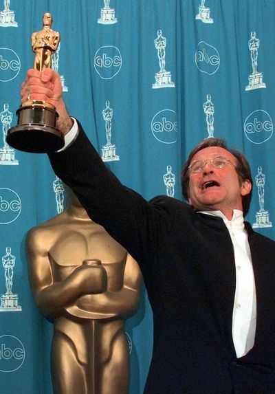 This March 23, 1998, photo shows Robin Williams holding his Oscar high backstage at the 70th Academy Awards in Los Angeles after he won Best Supporting Actor for “Good Will Hunting.” (Associated Press)