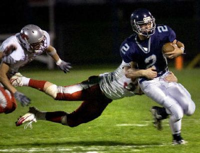 Lake City's Zach Clanton breaks several tackles before being brought down late in the Timberwolves' win. 
 (Jed Conklin / The Spokesman-Review)
