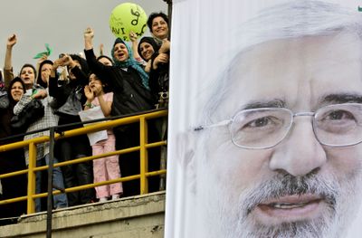 Supporters of reformist candidate Mir-Hossein Mousavi react after he arrives on the podium during a presidential campaign in Karaj, 24 miles west of Tehran, Saturday.  (Associated Press / The Spokesman-Review)