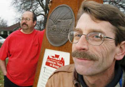 
Volunteers Glen Corbeil, left, and Mark Baltes stand next to one of the 17 steel monuments they constructed to commemorate the Oregon Trail route through Boise neighborhoods. 
 (Associated Press / The Spokesman-Review)