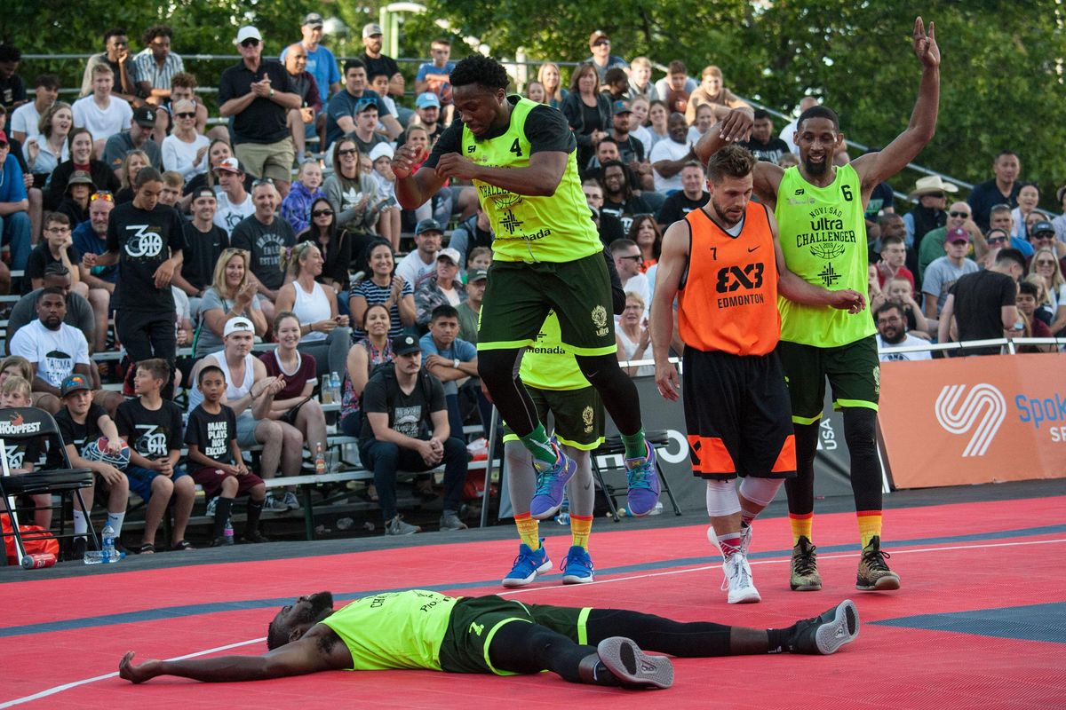 NY Harlem’s Marcel Esonwune, bottom, falls on to the court while Kidani Brutus jumps above him after they beat Edmonton during Spokane Hoops 3x3 World Invitational at Nike Center Court  on Friday. Harlem won the game and the $5,000 prize. Edmonton took home $2,500. (Kathy Plonka / The Spokesman-Review)