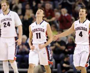 Gonzaga's David Stockton, center, and Kevin Pangos, right, celebrate a scoring run as they head to a timeout in the second half Saturday, Dec. 28, 2013 at the McCarthey Athletic Center. The Zags beat the Santa Clara Broncos 74-60. (Jesse Tinsley / The Spokesman-Review)