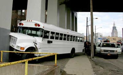 
An  11-year-old boy   grabbed  the wheel of a  runaway school bus and steered  it into a  pillar in Cleveland on Monday. Associated Press
 (Associated Press / The Spokesman-Review)