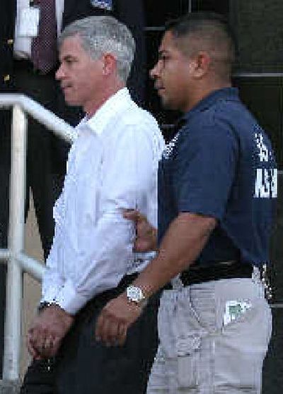 
Former Enron executive Andrew Fastow, left, leaves the federal court in chains on Tuesday. 
 (Associated Press / The Spokesman-Review)