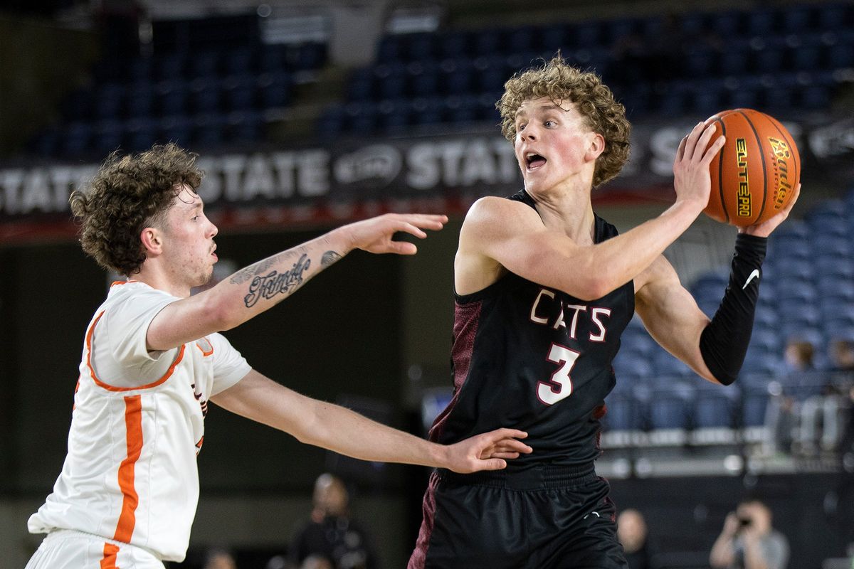 Mt. Spokane’s Ryan Lafferty, right, looks for an open teammate against the defense of Eastside Catholic’s Nate Krohn during action Friday, March 1, 2024, at the 3A State Boys Basketball Tournament in Tacoma, Wash. Mt. Spokane lost 55-53.  (Patrick Hagerty/For The Spokesman-Review)