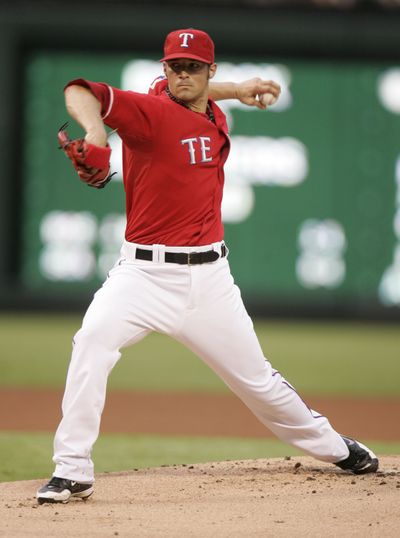 Rangers pitcher C.J. Wilson gave up four hits over eight innings against the Angels.  (Associated Press)